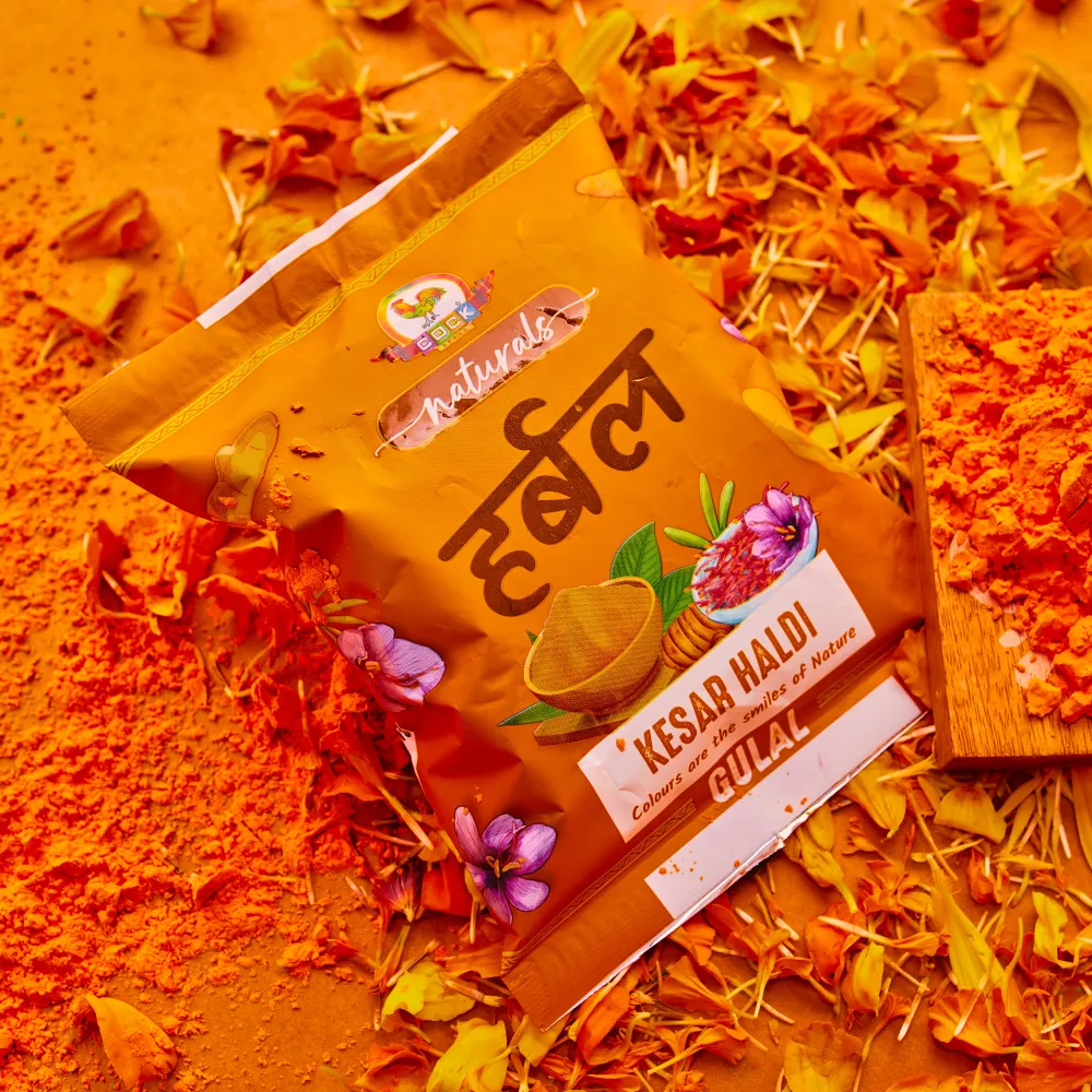 Kesar haldi herbal gulal pack on a spread of orange pigment