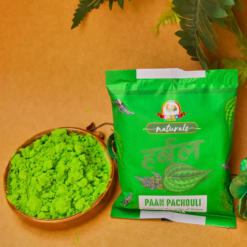 Paan pachouli herbal gulal pack beside a bowl of green pigment