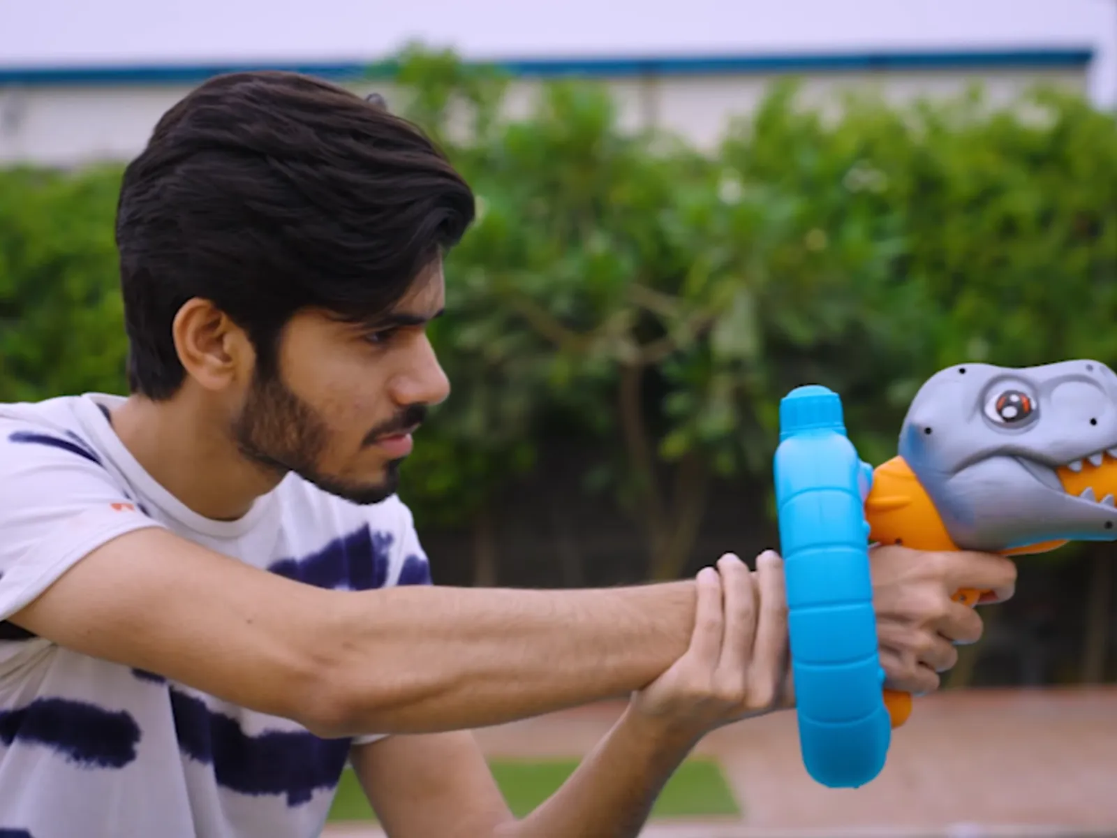 A pressure water gun being fired beside a pool